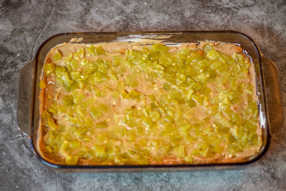 mexican bean dip covered with a diced chili layer