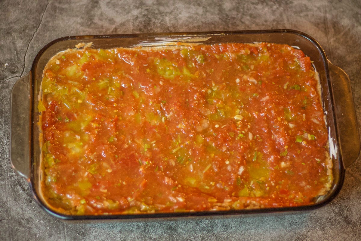 mexican bean dip covered with a salsa layer