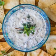 purslane dip over a plate of pita chips