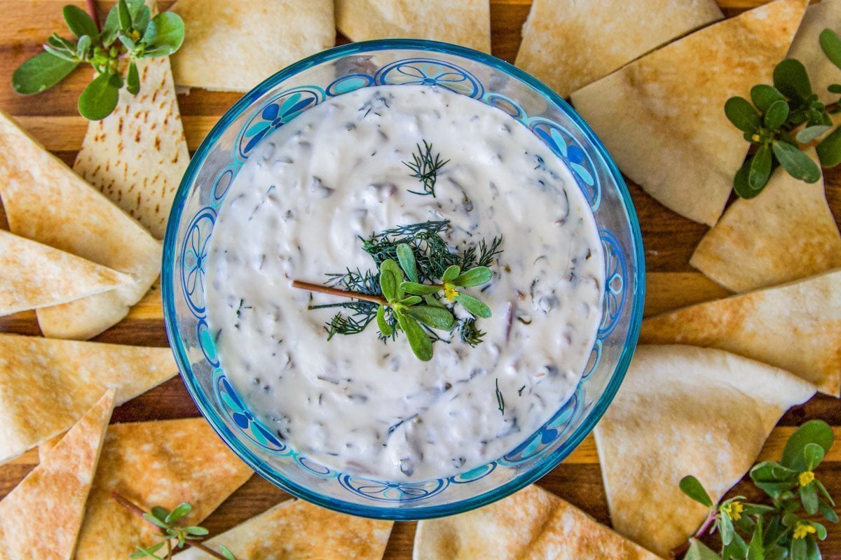 purslane dip over a plate of pita chips