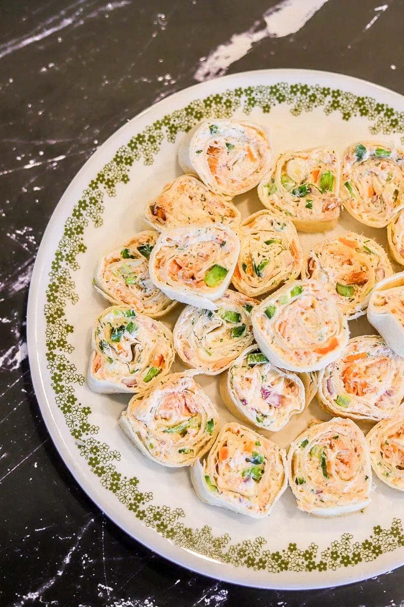 smoked salmon rolls on a white plate.