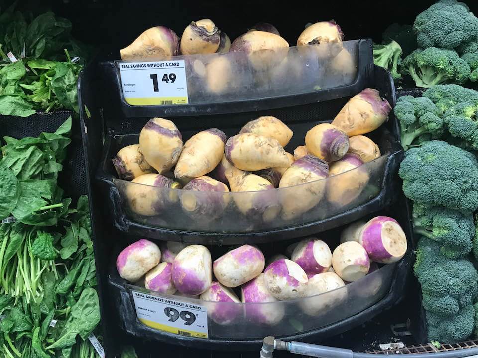 turnips and rutabagas in a grocery display