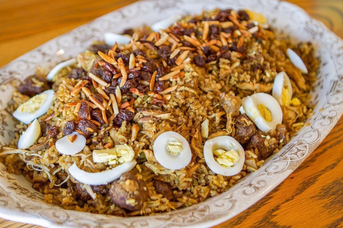 biryani plate with almonds, raisins, and sliced boiled eggs