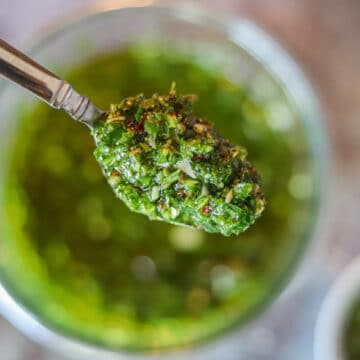 chimichurri in a spoon over a jar
