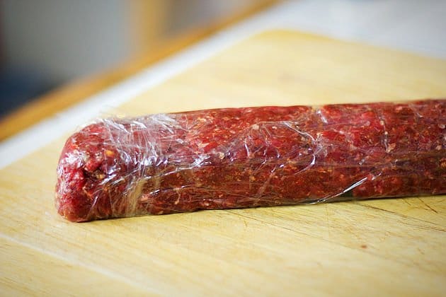 raw basturma sausage wrapped in plastic
