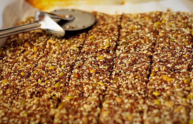 seed cracker mix on a cookie sheet cut into portions
