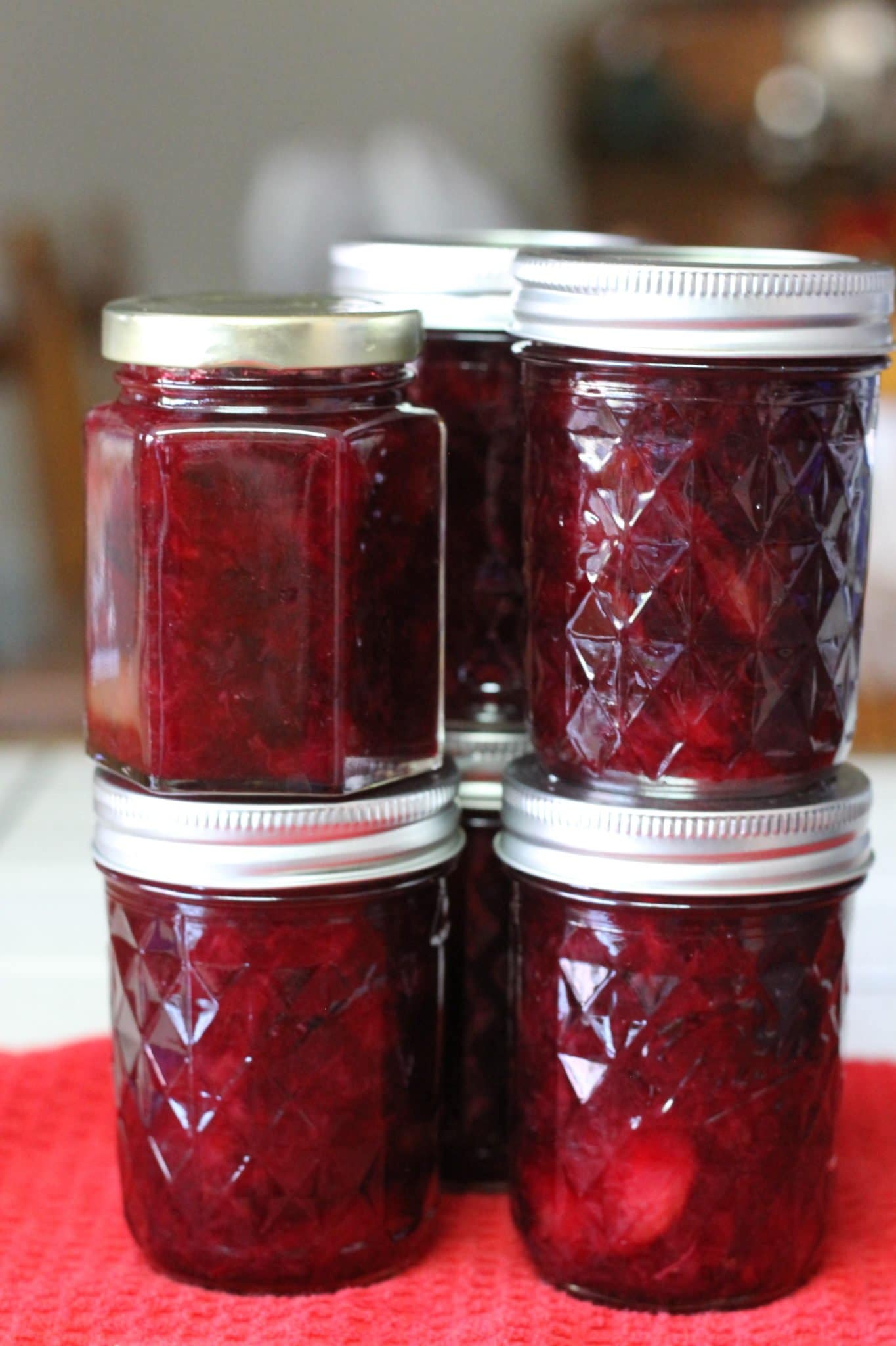 staked jars of plum preserves 