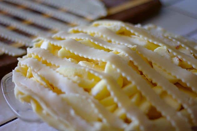 unbaked pie covered in strips of pastry