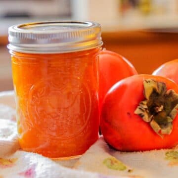 persimmon jam with a few persimmons on the side