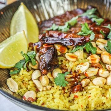 coconut rice with peanuts, pork, lime wedges