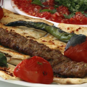 kofta kabob on lavash bread with grilled tomatoes and chilis
