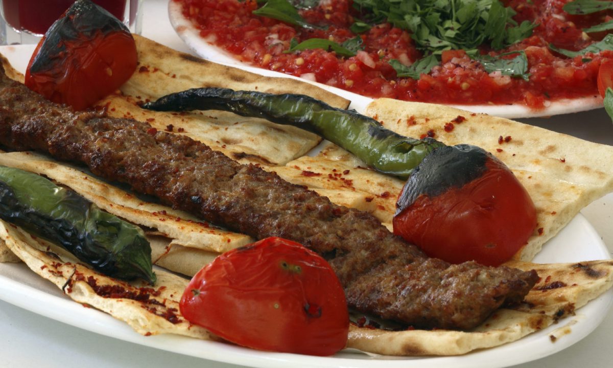 kofta kabob on lavash bread with grilled tomatoes and chilis