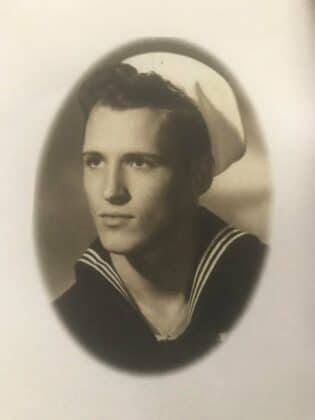 a vintage black and white photo of a young, handsome sailor.