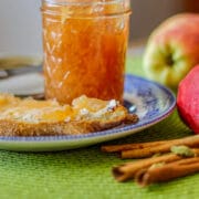 apple pie preserves on toast and in jar with apples and cinnamon sticks
