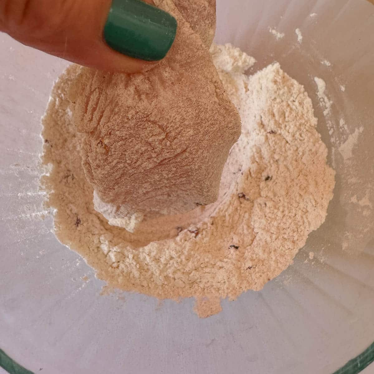 chicken being dredged in seasoned flour