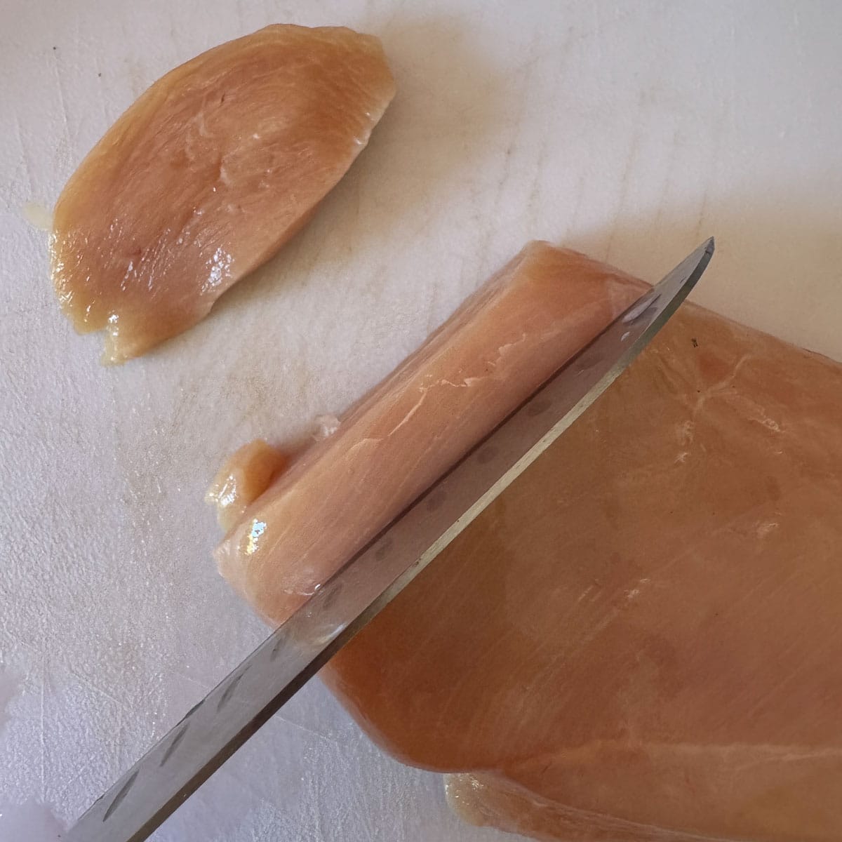 chicken breast being sliced