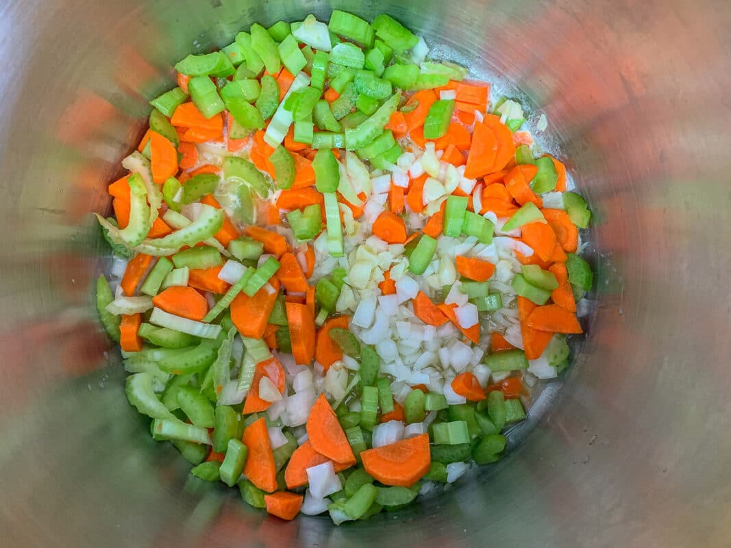 carrots, onions, and celery being sautéed
