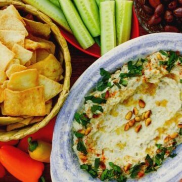 Baba Ghanoush dip with chips and veggies and pita chips on the side