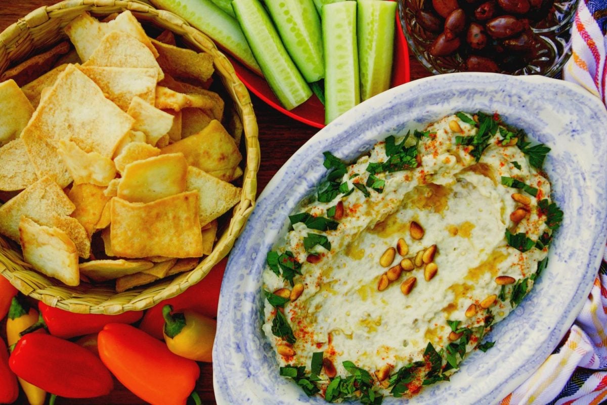 Baba Ghanoush dip with chips and veggies and pita chips on the side