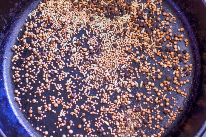 corned beef spices being toasted in a pan