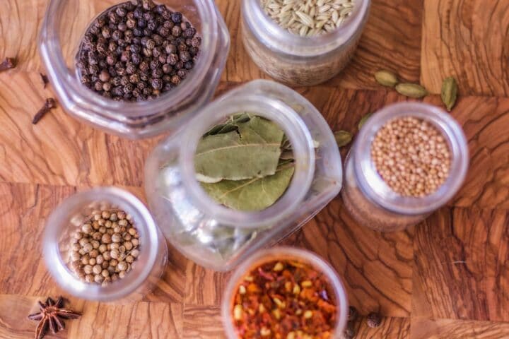 spice jars on a wooden cutting board