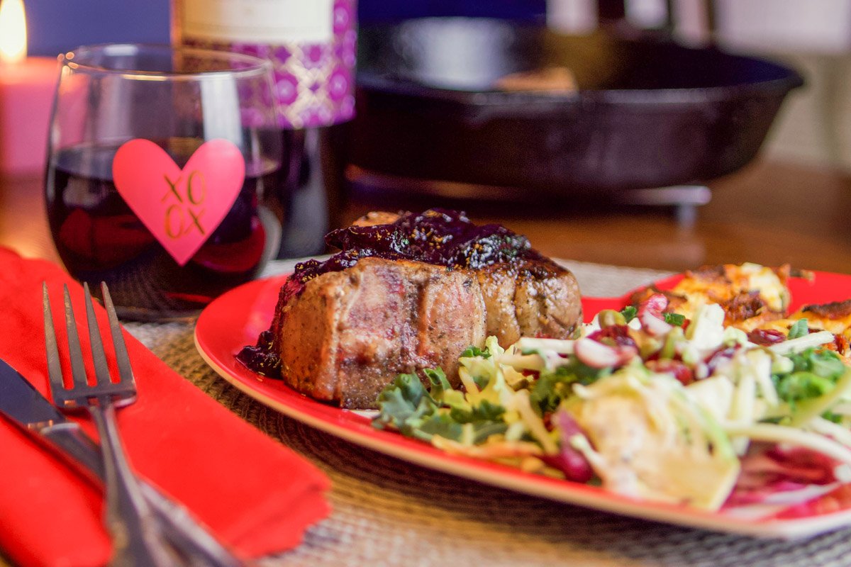 lamb with cherry sauce on a plate