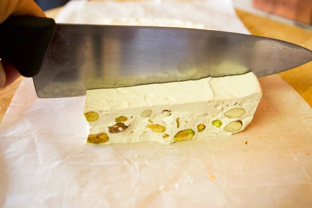 cutting into nougat with a sharp knife