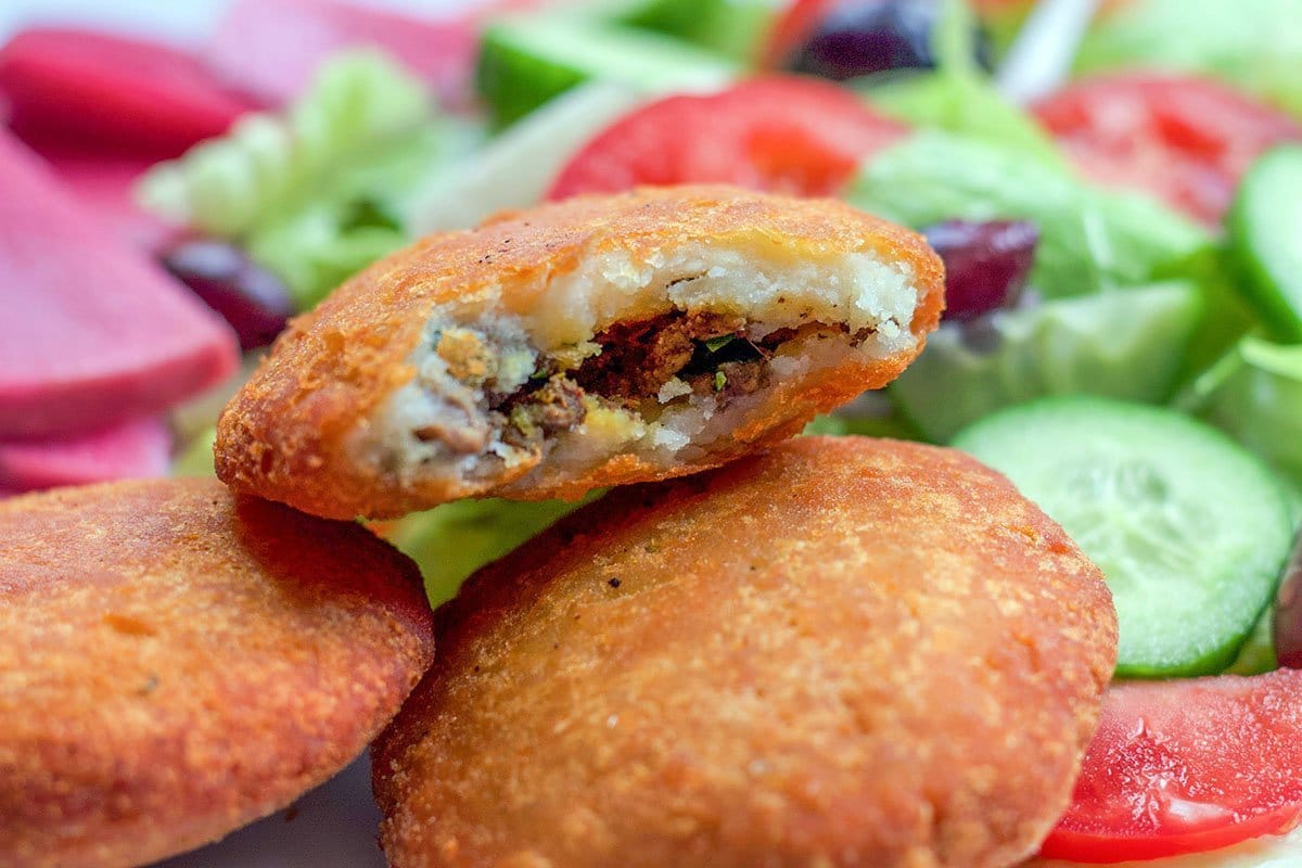 potato chops on a plate with a salad