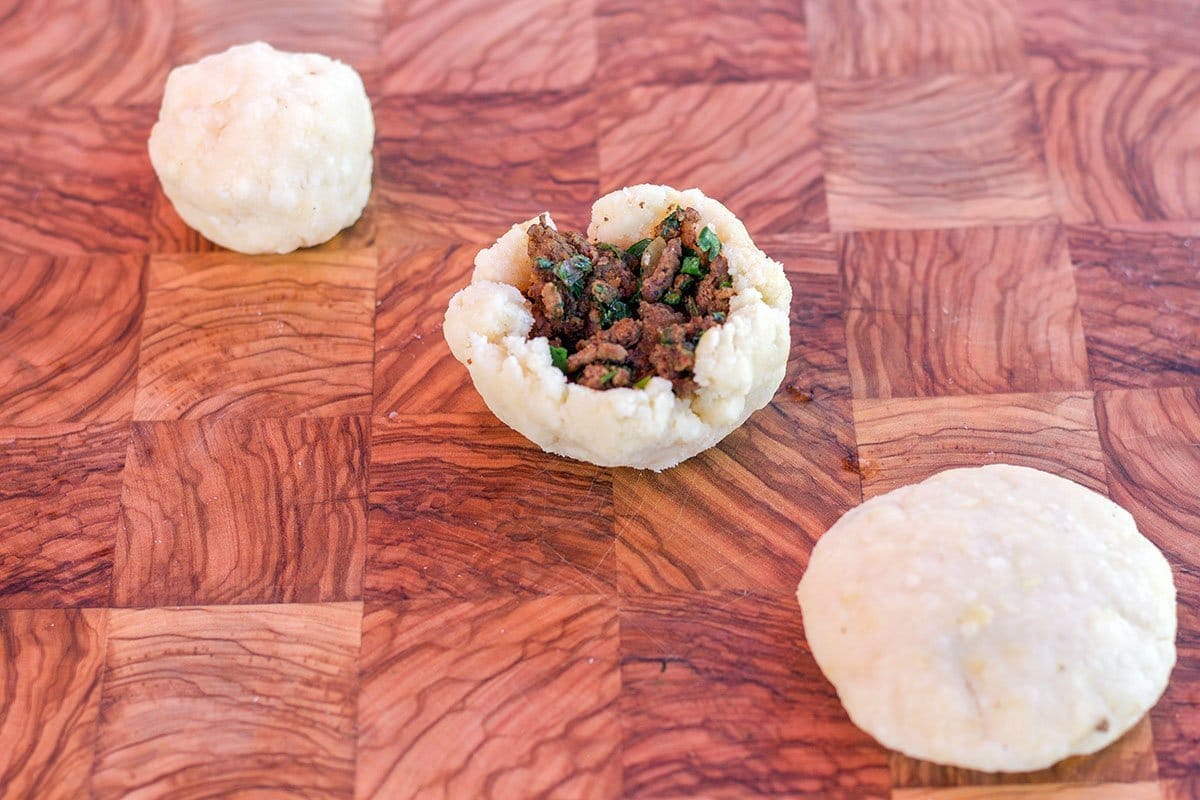 3 potato chops on a cutting board