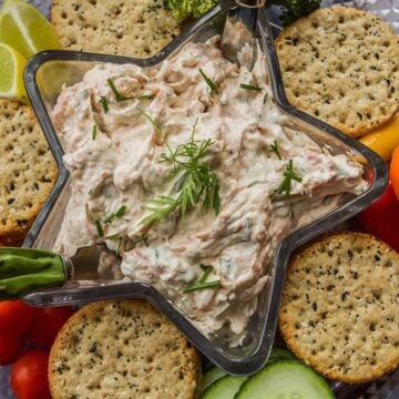 smoked salmon dip in a star shaped dish with crackers and vegetables