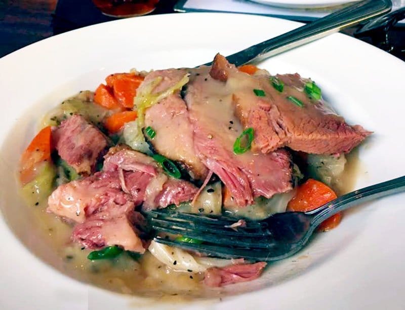 corned beef and carrots and potatoes on a white plate