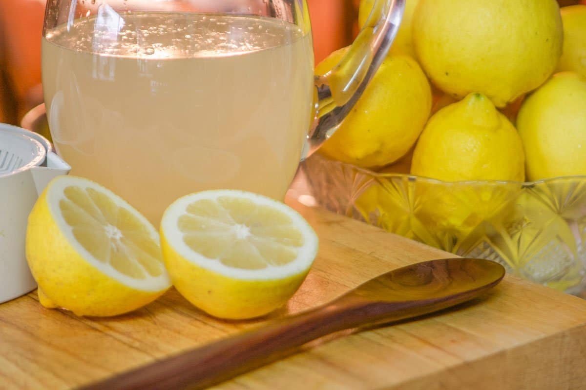 lemonade in a jar with lemons around it