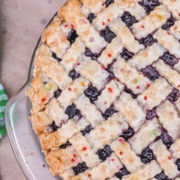 lattice top mulberry pie with a green and white napkin