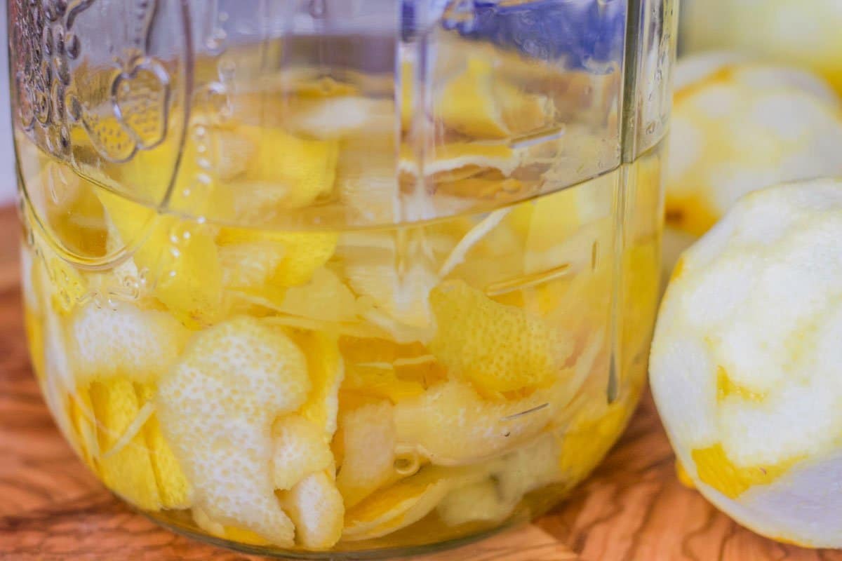 alcohol and lemon peels in a mason jar