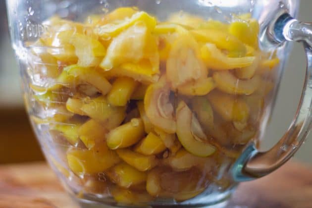 sliced and seeded loquats in a large measuring cup