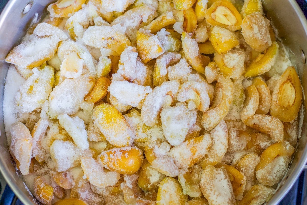 loquats covered with sugar in a pot for loquat jam