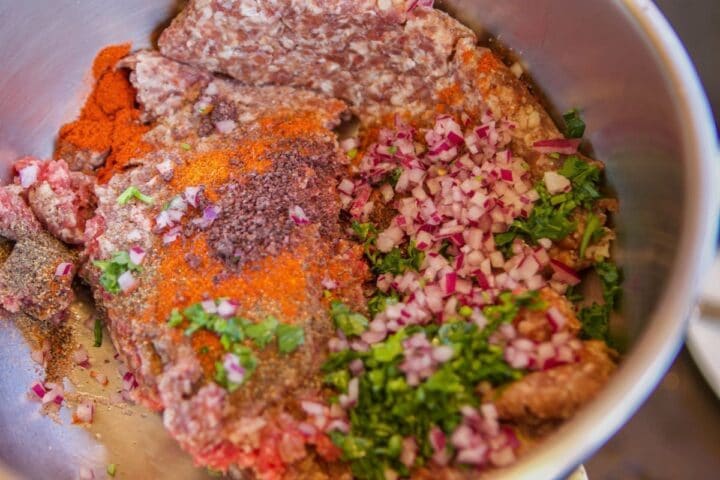 raw elk meat with onions, parsley and spices