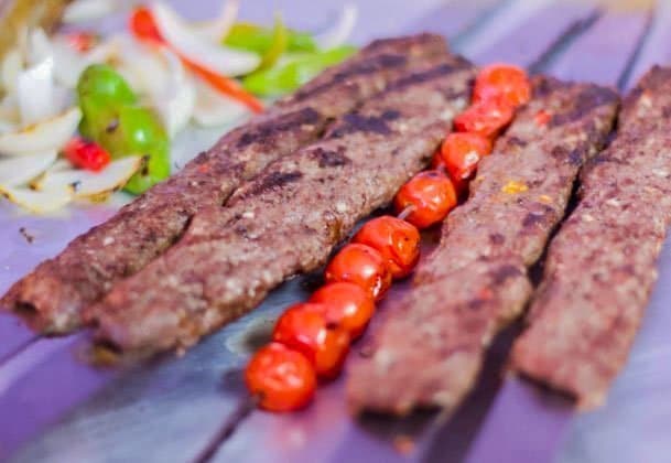 Goat Kofta Kabobs with skewered tomatoes and salad