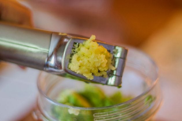 crushed garlic in a garlic press