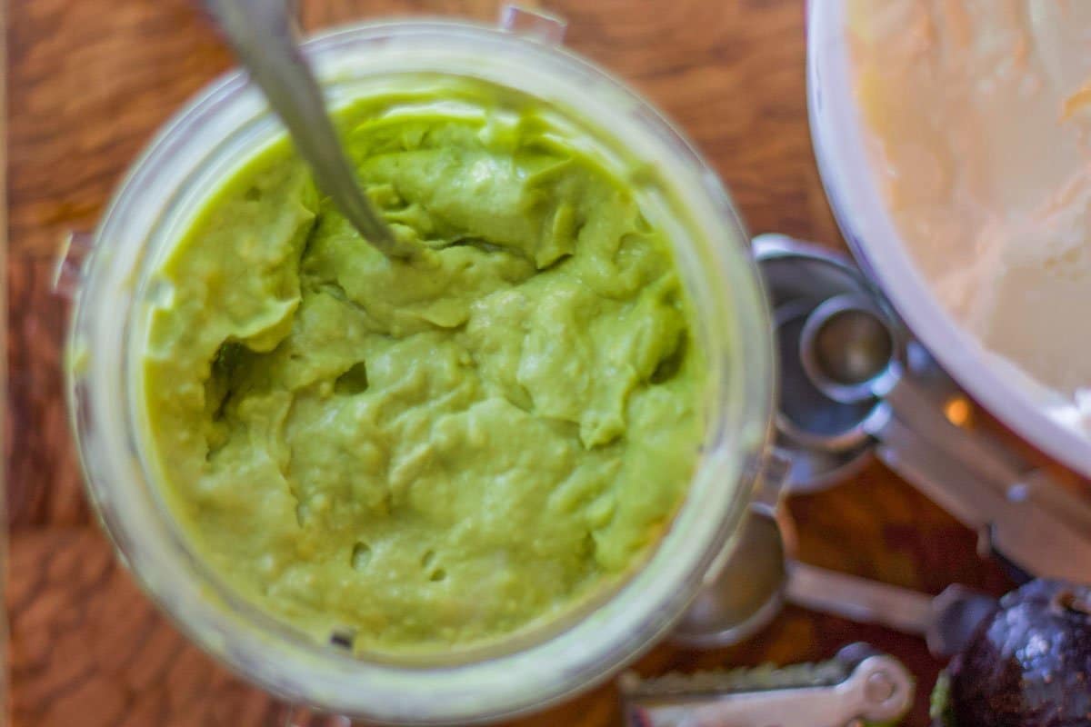 creamy guacamole in a plastic cup