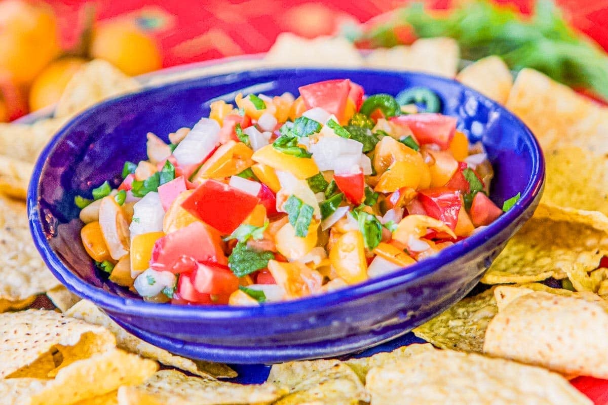 loquat fruit salsa in a blue bowl with chips.