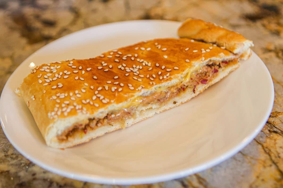 a slice of bean and cheese pasty on on a white plate