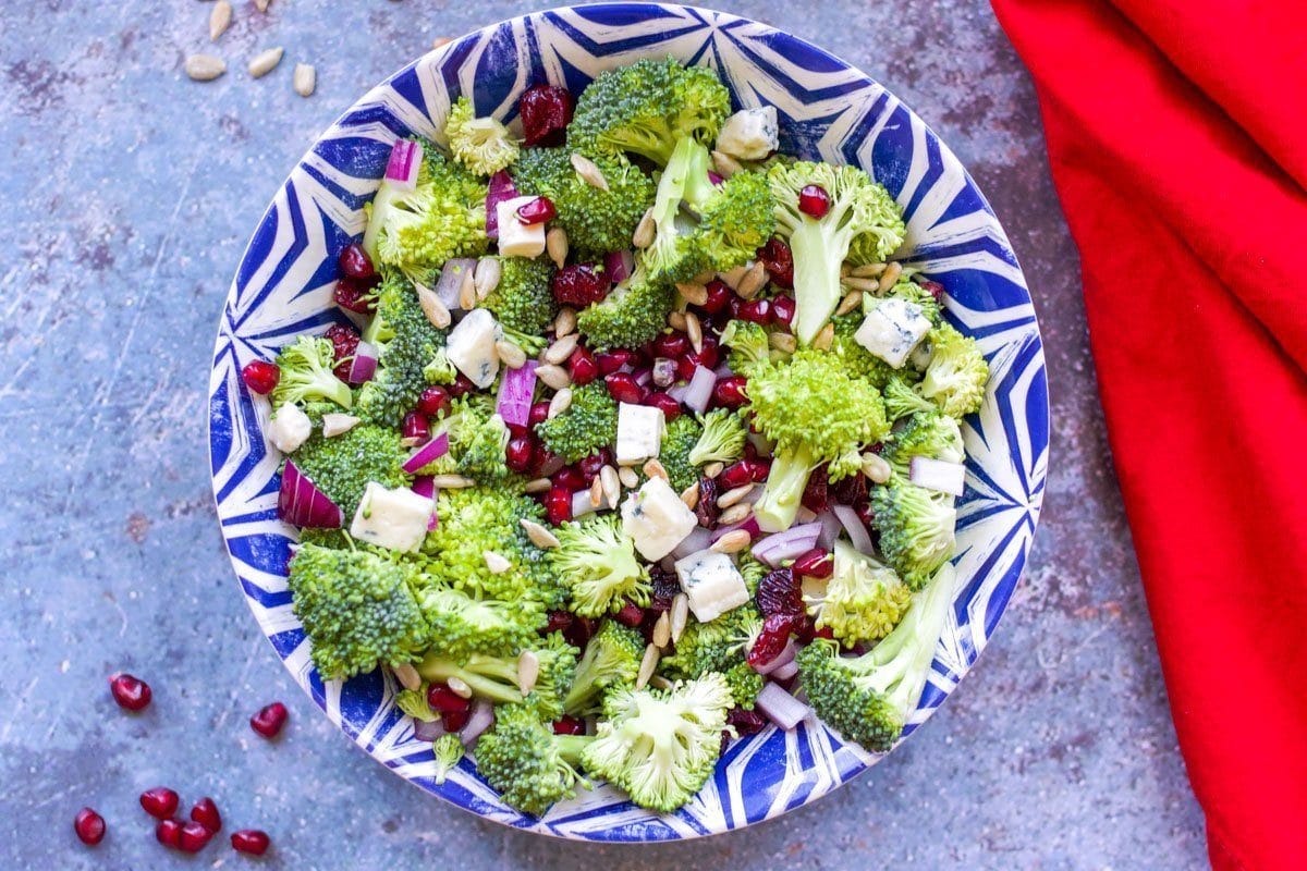 broccoli salad in a blue bowl with a red napkin