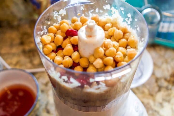 food processor with chick peas and other ingredients