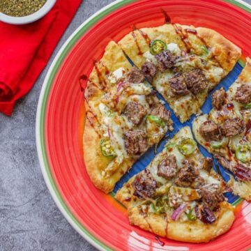 shawarma pizza on a red plate
