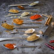 baharat spice blend in spoons on counter