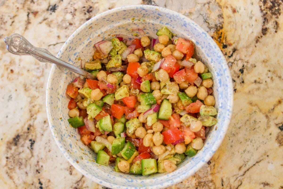 chickpea salad with a spoon in it