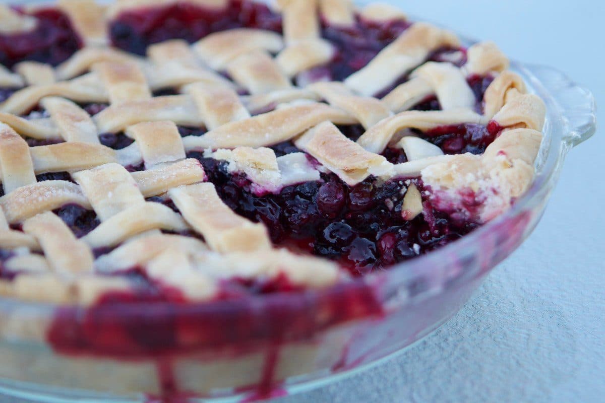 huckleberry pie with a slice missing