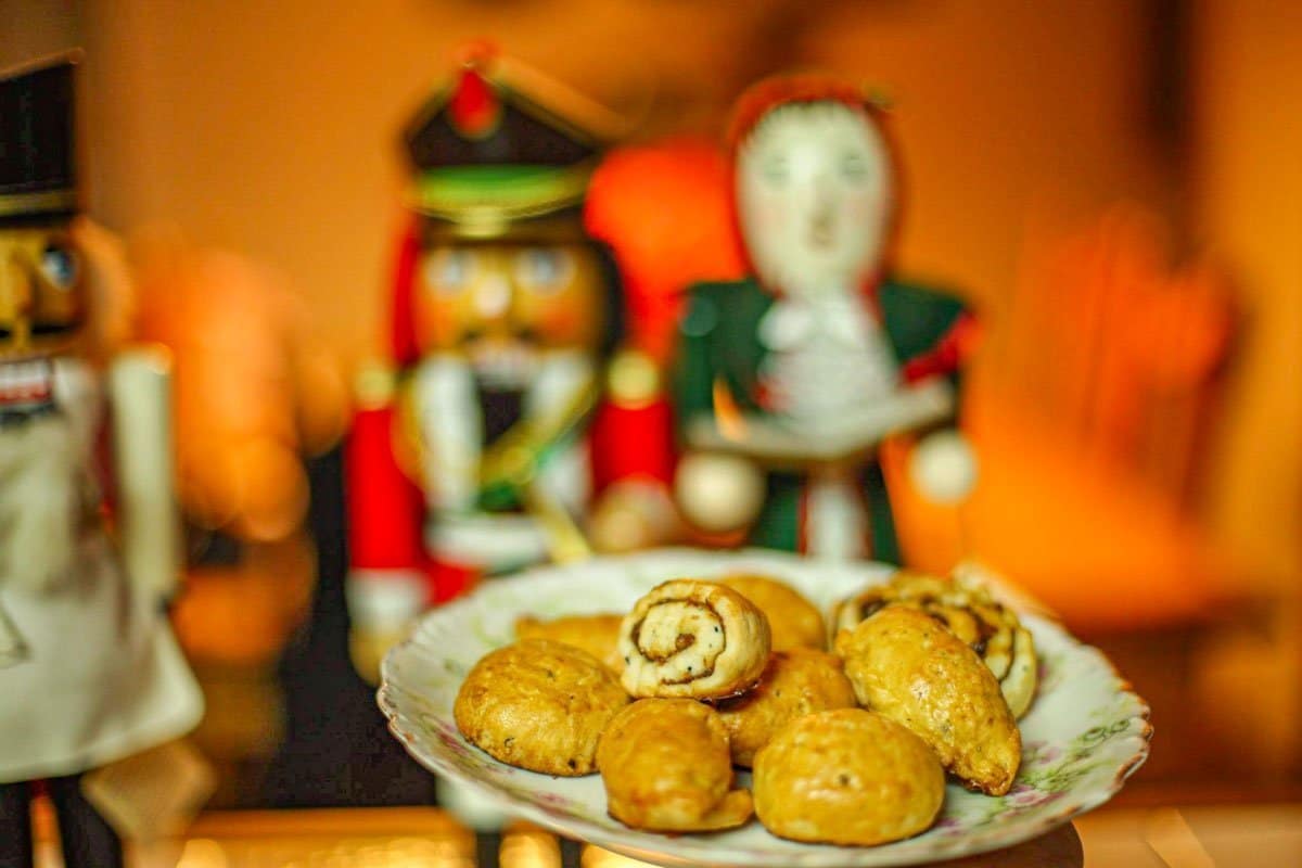 a plate of Assyrian cookies with nut crackers in the background