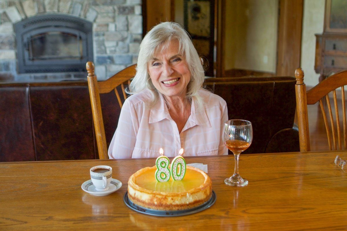 a lady and her 80th birthday cake 